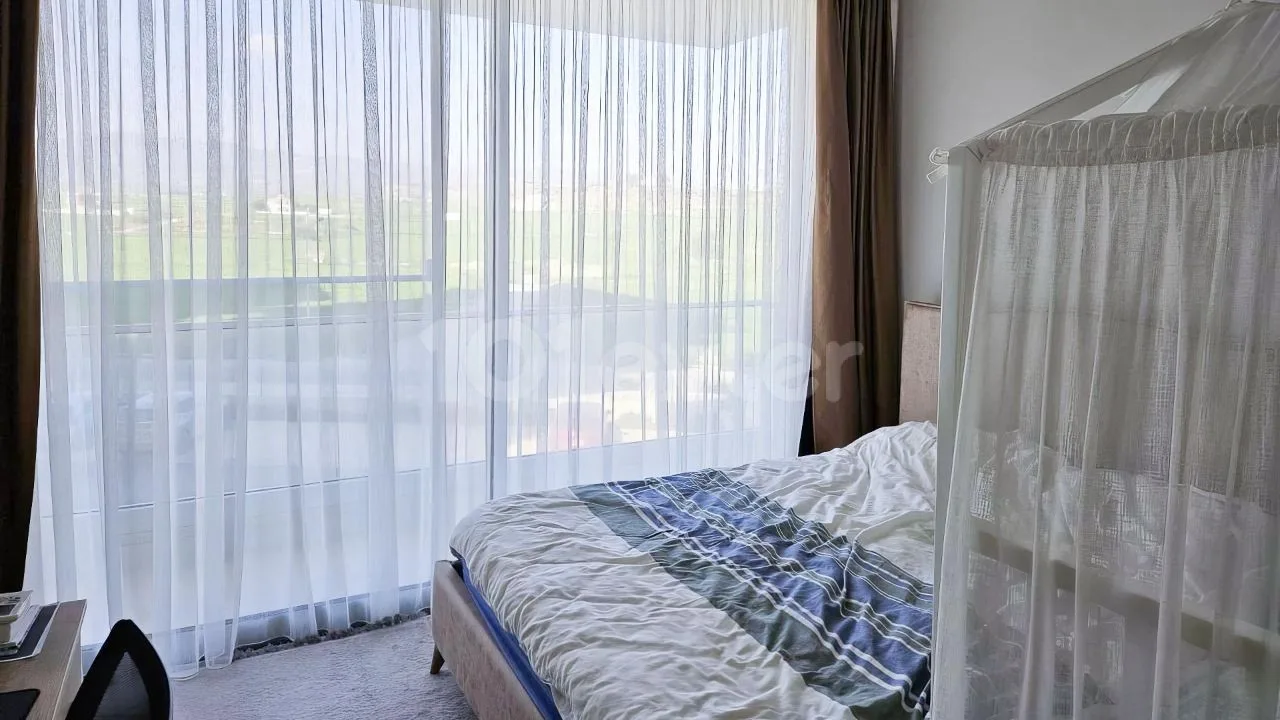 Bedroom with a sea-facing window in the Abelia Residence apartment