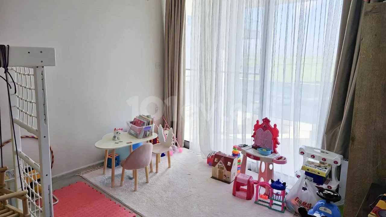 Children's play area beside the apartment's full-height windows